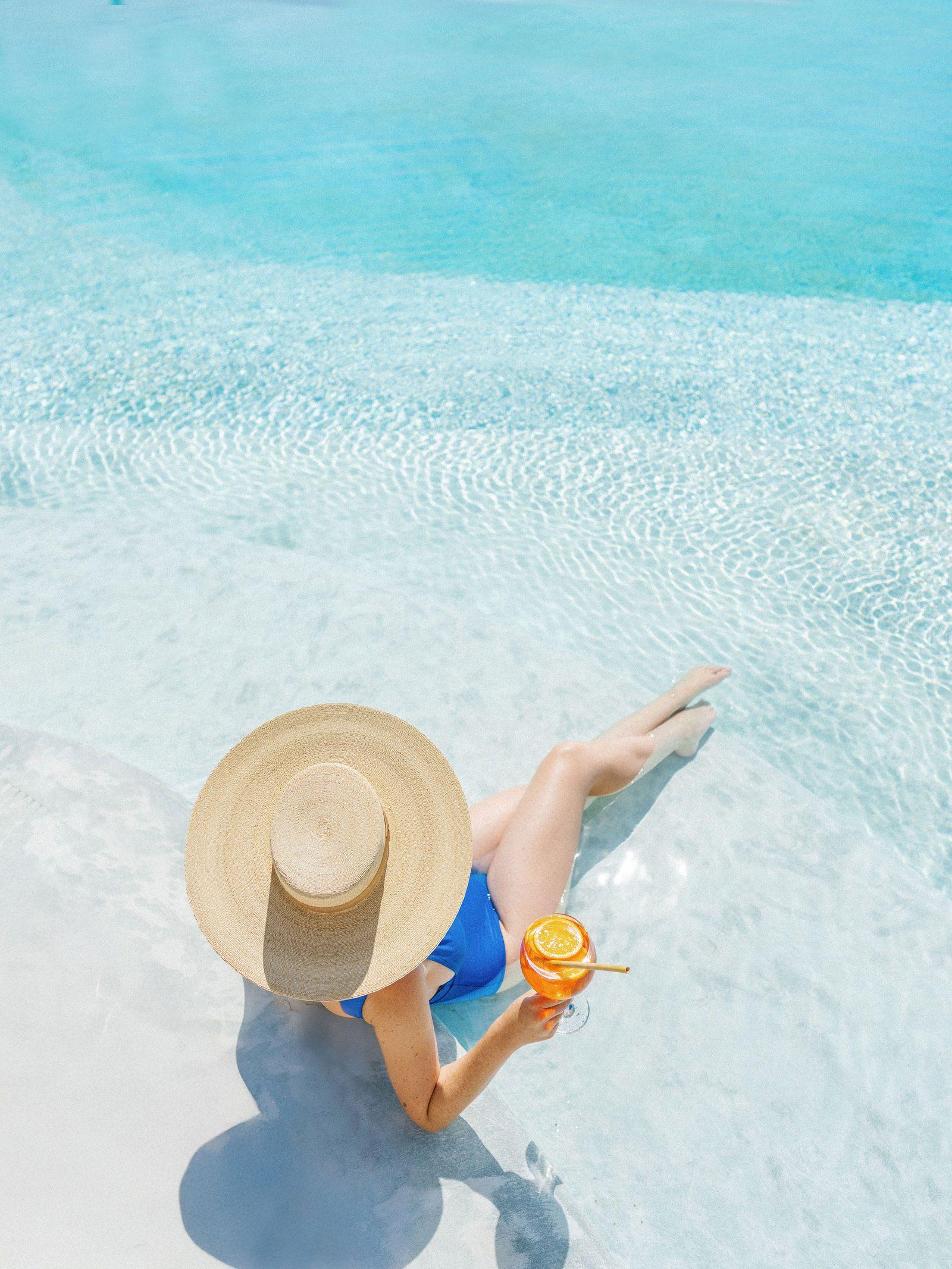 A guest floating in clear shallow water
